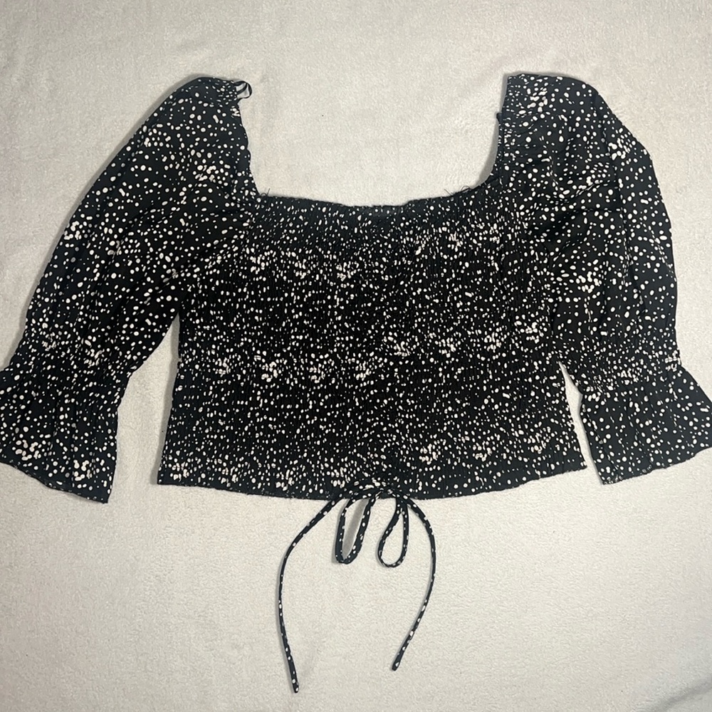 Timing ruffled black and white polkadot top
